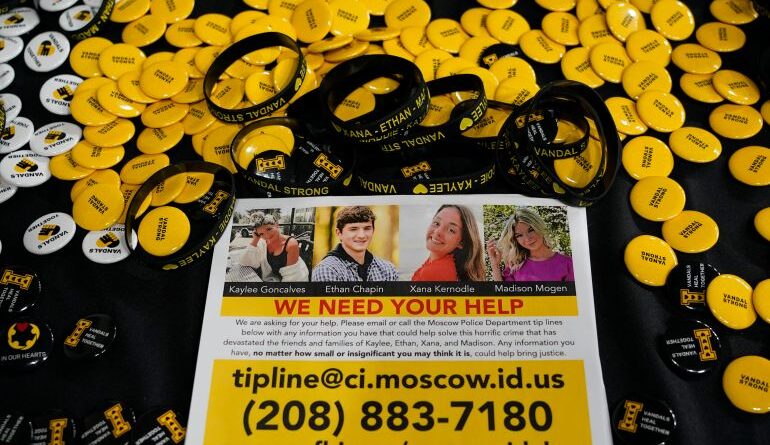 FILE - A flyer seeking information about the killings of four University of Idaho students who were found dead is displayed on a table along with buttons and bracelets on Nov. 30, 2022, during a vigil in memory of the victims in Moscow, Idaho. Attorneys for Bryan Kohberger, the man charged with stabbing four University of Idaho students to death, are expected to ask a judge to move the trial away from the rural college town where the killings occurred. (AP Photo/Ted S. Warren, File)