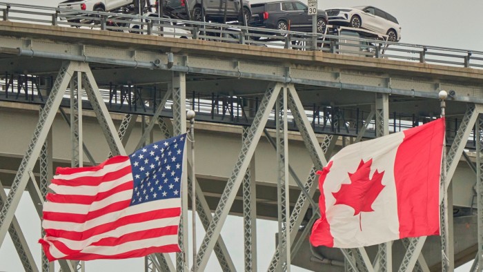 A truck carrying vehicles crosses the Blue Water Bridge into the US from Sarnia, Ontario