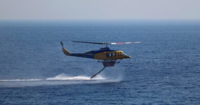 A firefighting helicopter picks up water from the sea, as a wildfire burns near Ierapetra, on the island of Crete, Greece on July 3 2025