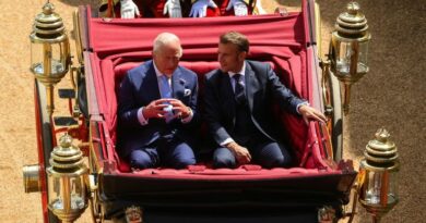 Britain's King Charles and French President Emmanuel Macron sit on a carriage as they arrive at Windsor Castle, in Windsor, Britain, July 8, 2025.