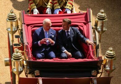 Britain's King Charles and French President Emmanuel Macron sit on a carriage as they arrive at Windsor Castle, in Windsor, Britain, July 8, 2025.
