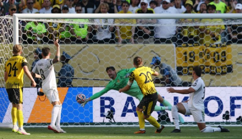 Real Madrid's Thibaut Courtois saves a shot from Borussia Dortmund's Marcel Sabitze