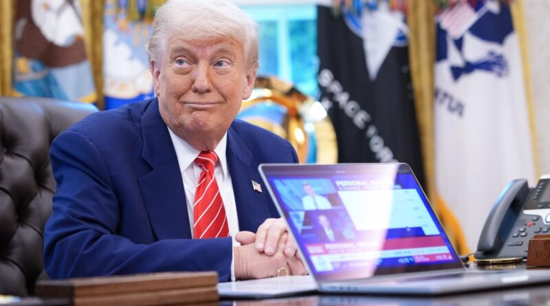 President Donald Trump,shows a news video from a laptop in the Oval Office of the White House on May 30, 2025 in Washington, DC.