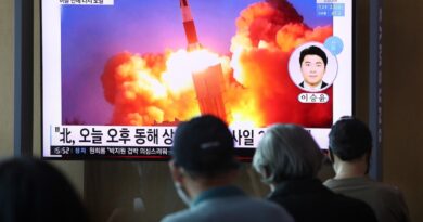 people watching a TV at the Seoul Railway Station showing a file image of a North Korean missile launch, on September 15, 2021 in Seoul, South Korea