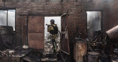 a firefighter stands in a burnout out building