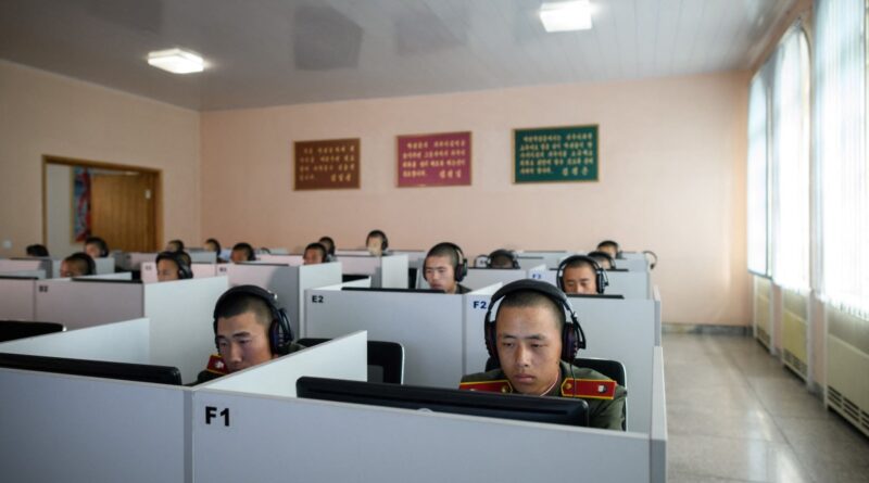 Students wearing Korean People's Army (KPA) uniforms sit before computer screens as they attend a class at the Mangyongdae Revolutionary School outside Pyongyang.