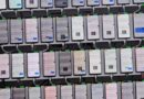 a photo showing a rack containing dozens of smartphones mounted and being used to automate scam messages. the photo was found in a Telegram group used by the scammers.