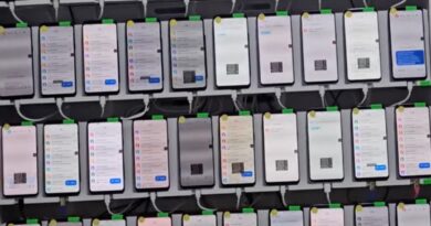 a photo showing a rack containing dozens of smartphones mounted and being used to automate scam messages. the photo was found in a Telegram group used by the scammers.