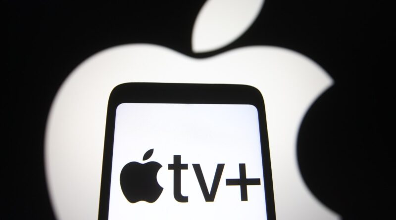 In this photo illustration an Apple TV+ logo is seen on a smartphone screen with an Apple logo in the background.