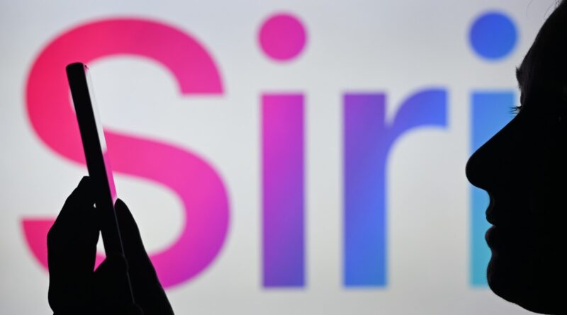 An image of a woman holding a cell phone in front of the Siri logo displayed on a computer screen.
