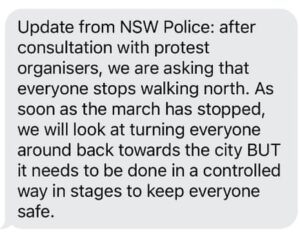 Screenshot of a message from NSW Police to protesters walking across the Sydney Harbour Bridge on 3 Aug 2025 to stop walking north, turn around and walk back to CBD