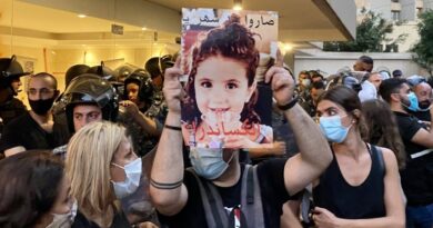 A protester holds up a picture of three year-old Alexandra Naggear, who was killed in the Beirut Port explosion. (Kareem Chehayeb)