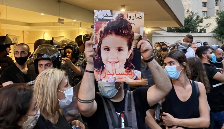 A protester holds up a picture of three year-old Alexandra Naggear, who was killed in the Beirut Port explosion. (Kareem Chehayeb)