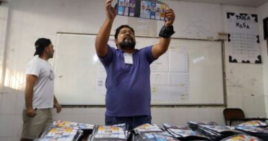a man looks at a piece of paper with faces on it