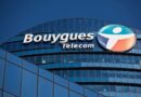 a logo outside the headquarters of Bouygues Telecom, against a blue sky background