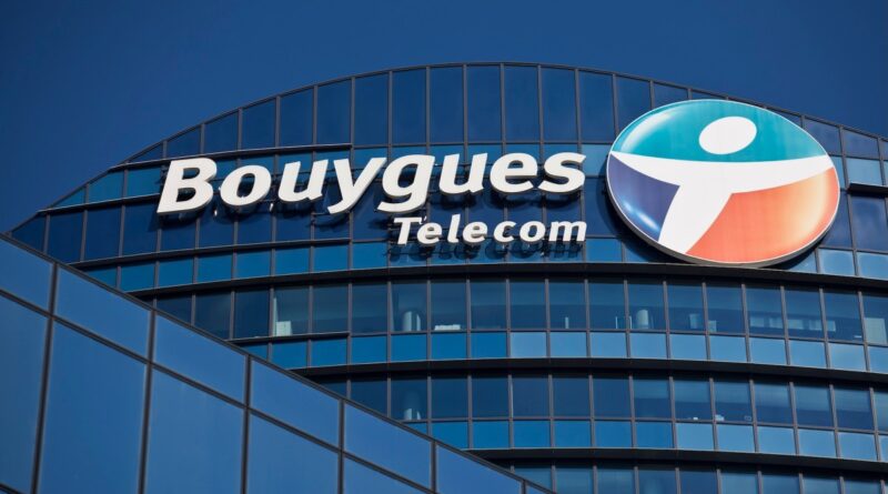 a logo outside the headquarters of Bouygues Telecom, against a blue sky background