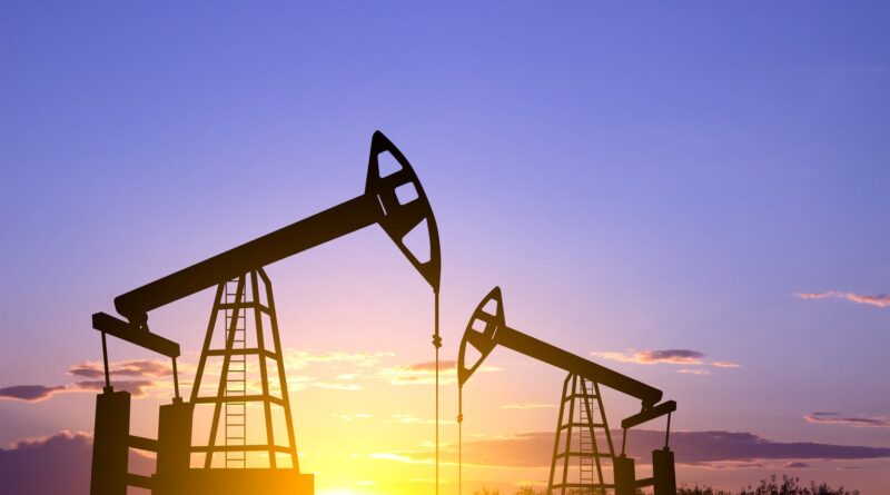 Silhouette of Oil pump. Industrial machine for petroleum on background of sunset