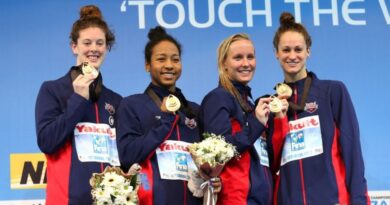 Members of the US relay team (L-R) Allison Schmitt, Lia Neal, Jessica Hardy and Megan Romano pose with their gold medals on the podium after winning the women's 4x100m freestyle relay final during the Short Course Swimming World Championships