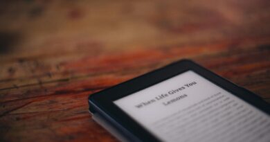 Amazon Kindle e-reader laying on a wooden surface