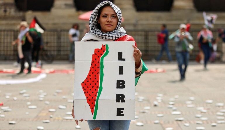 A protester holds a sign during a demonstration demanding an immediate ceasefire in Gaza, as the conflict between Israel and the Palestinian Islamist group Hamas continues, in Bogota, Colombia, January 27, 2024. REUTERS/Luisa Gonzalez TPX IMAGES OF THE DAY