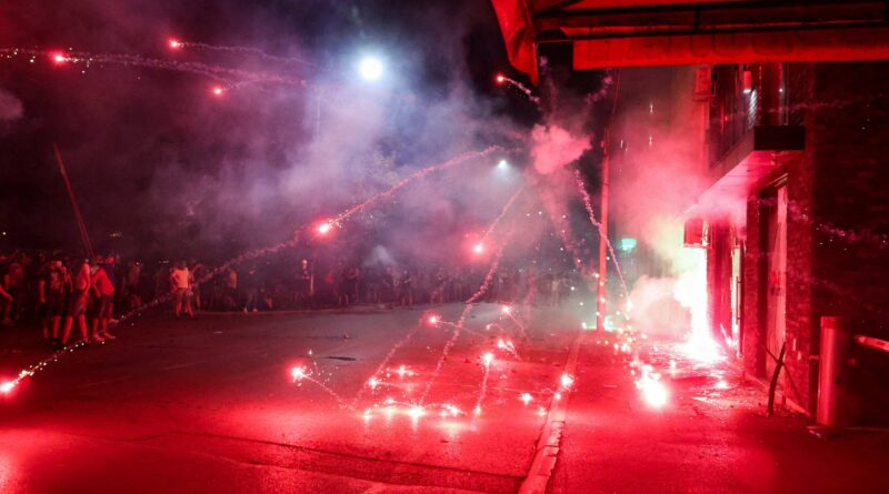 Photos: Protesters clash with police, torch Serbia’s ruling party offices
