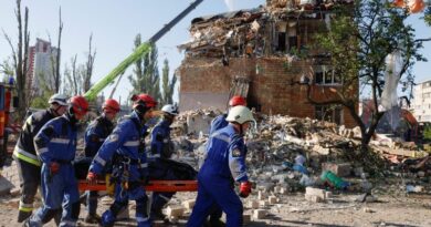 Rescuers carry a casualty in Kyiv
