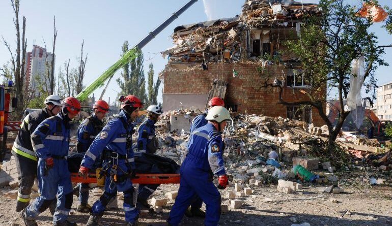 Rescuers carry a casualty in Kyiv