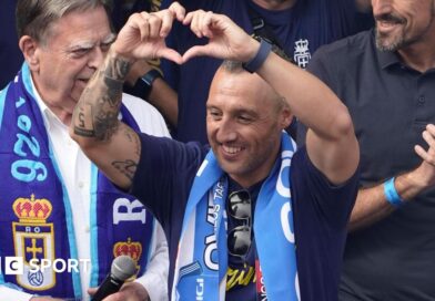 Santi Cazorla makes a heart sign with his fingers to Real Oviedo supporters 