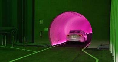 A Tesla car drives through a tunnel in the Central Station during a media preview of the Las Vegas Convention Center Loop