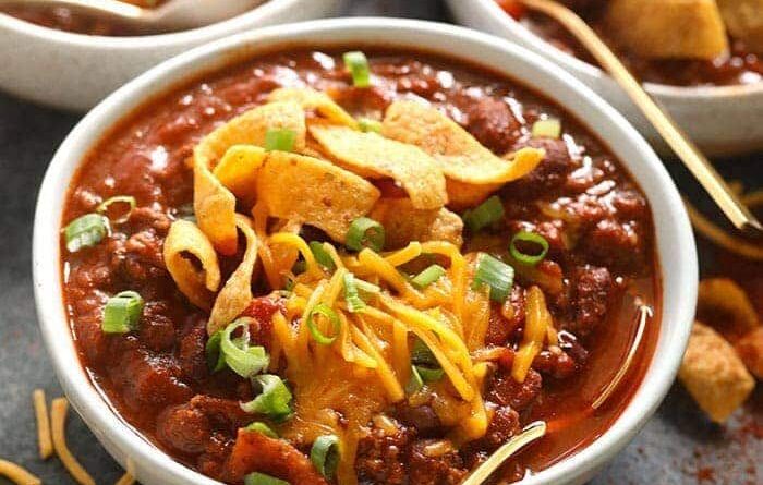 Three bowls of the best chili, served with tortilla chips.
