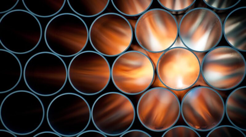 Pipes are backlit, causing them to appear to glow orange.