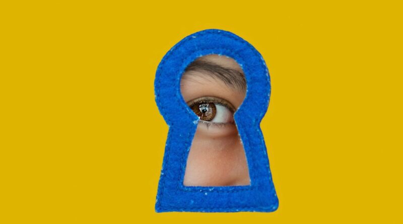 a child looking through a blue keyhole