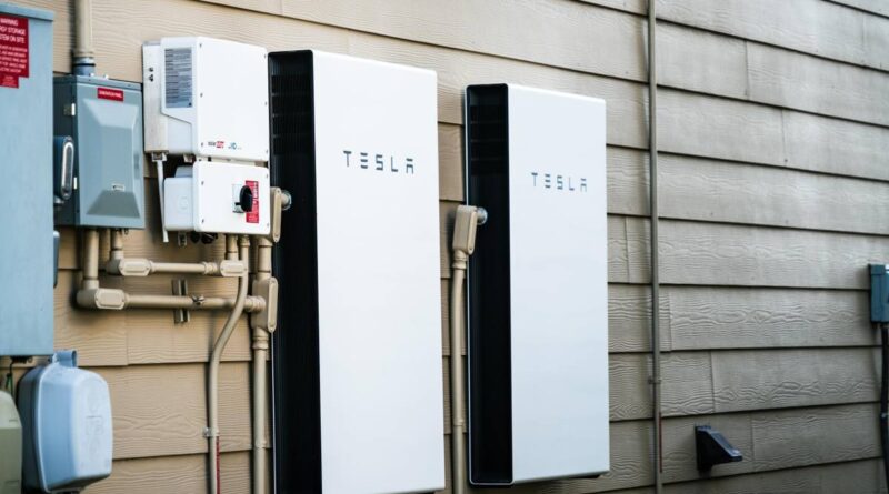 Two Tesla Powerwalls sit on the outside of a house.