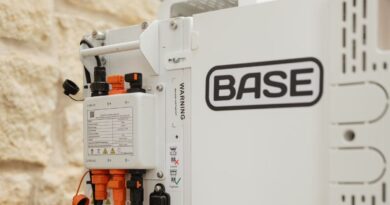A Base Power battery sits next to a home.