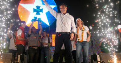 FOR BRIAN OSGOOD Rodrigo Paz stands on stage at a rally with supporters as small fireworks go off to either side