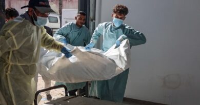 Hospital workers transport the remains of a Palestinian released by Israel under a Gaza ceasefire and hostage exchange deal, to the morgue of Nasser hospital in Khan Yunis in the southern Gaza Strip, on October 18, 2025. Israel returned the bodies of 15 Palestinians to Gaza on October 18, bringing the total number handed over to 135, the health ministry in the Hamas-run territory said.