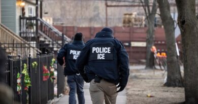 US Immigration and Customs Enforcement (ICE) agents walk down a street during a multi-agency targeted enforcement operation in Chicago, Illinois, US, on Sunday, Jan. 26, 2025.