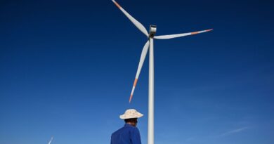A man in front of a wind turbine in Vietnam