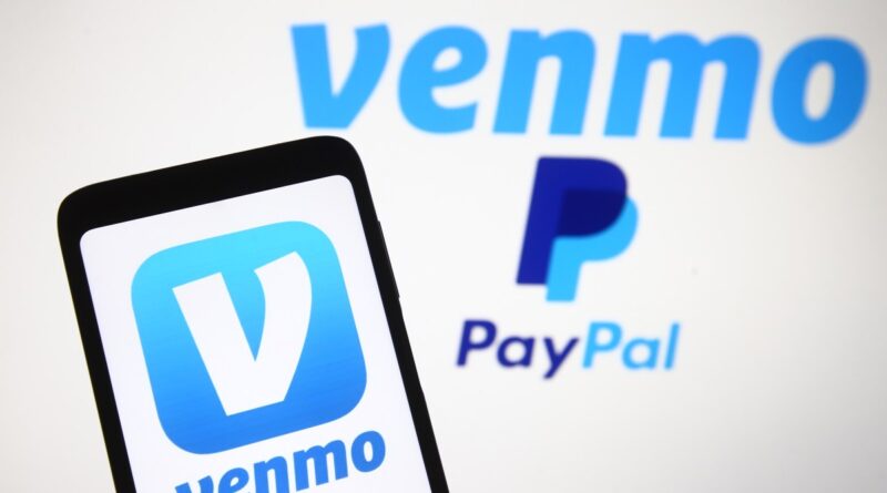 Venmo logo, a mobile payment service of PayPal is seen displayed on a smartphone and a PC screen.