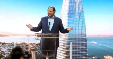 Marc Benioff standing at a podium in front of a backdrop of Salesforce Tower.