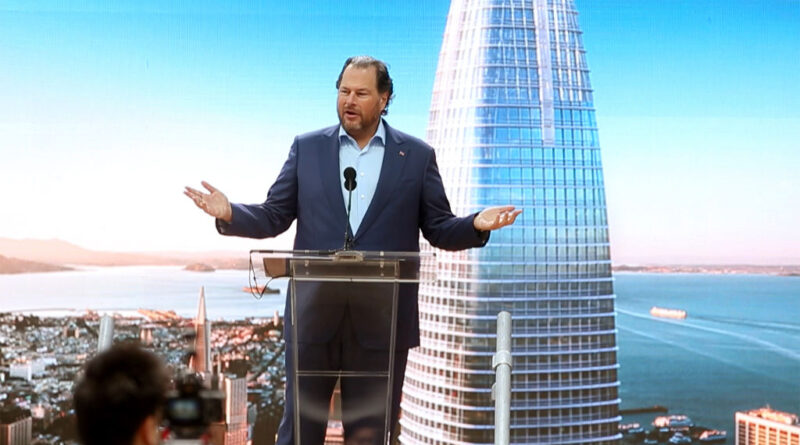 Marc Benioff standing at a podium in front of a backdrop of Salesforce Tower.