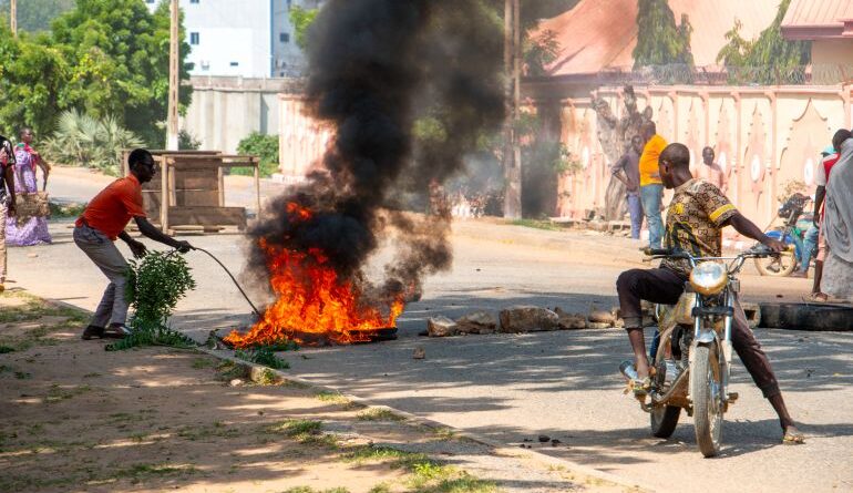 Burning barricades are seen in Garoua during a demonstration by supporters of the political opposition on October 21, 2025 ahead of the release of the results of the presidential vote. (Photo by AFP)