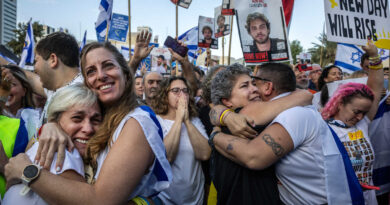 People embracing in Hostages Square.