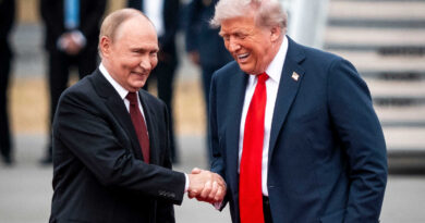President Trump and President Vladimir V. Putin are shaking hands and laughing on a red carpet.