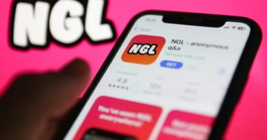 NGL on App Store displayed on a phone screen and NGL website displayed on a screen in the background are seen in this illustration photo