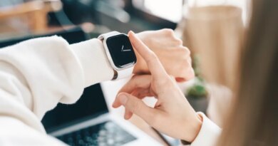 Modern woman using smart watch for daily tasks, interacting with the touchscreen user interface. Tracking health habits, messaging, checking on time with simple application software.