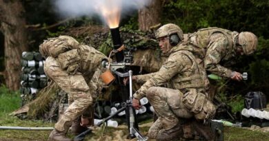 Three soldiers in camouflage uniforms operate an 81mm mortar, with one firing the weapon as smoke and flame are visible from the barrel.