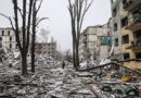 A Ukrainian serviceman walks through rubble between destroyed residential buildings and leafless trees in Kostyantynivka.