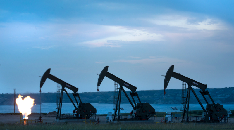 View of three oil wells and flaring of natural gas on The Fort Berthold Indian Reservation near New Town, ND