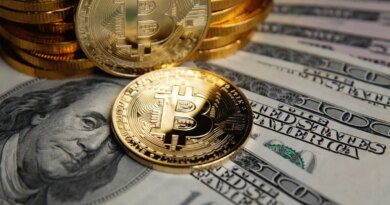 Bitcoin coins cryptocurrency on U.S. dollar banknotes background.